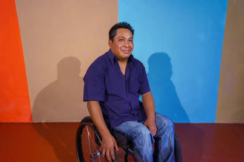 Disabled man in wheelchair smiling at camera