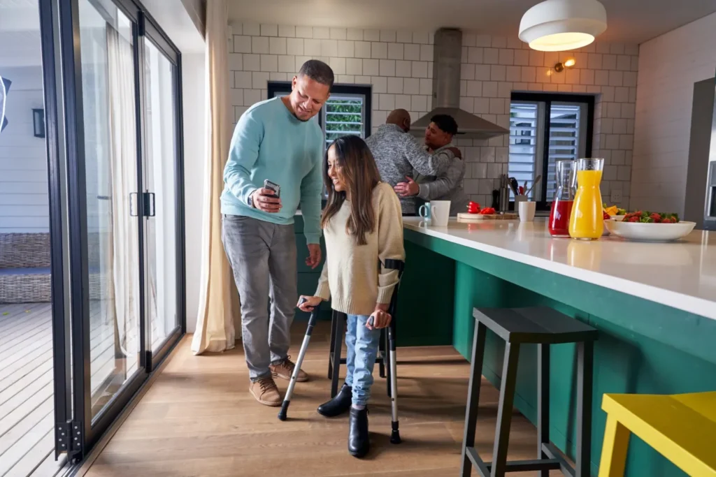 Disabled woman in kitchen with support worker